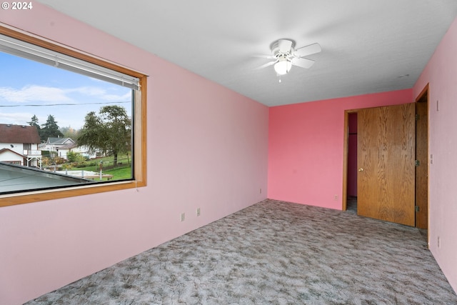 unfurnished room featuring carpet floors and ceiling fan