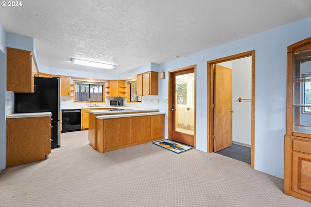 kitchen featuring black dishwasher, light carpet, a peninsula, light countertops, and a textured ceiling