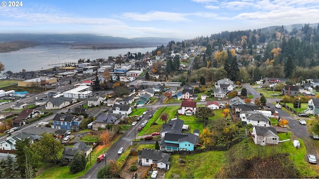 aerial view of property's location with a large body of water and nearby suburban area