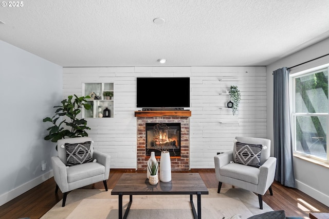 5346 NW Wickiup Way, Portland, OR 97229 - living area featuring a textured ceiling, wood finished floors, and a brick fireplace