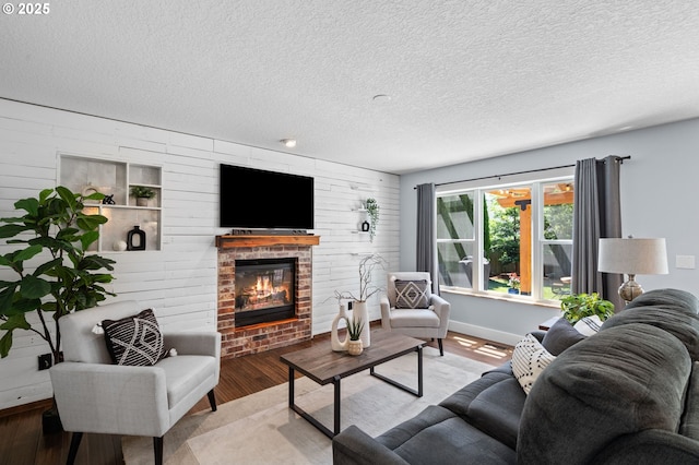 5346 NW Wickiup Way, Portland, OR 97229 - living area with a brick fireplace, wood finished floors, and a textured ceiling
