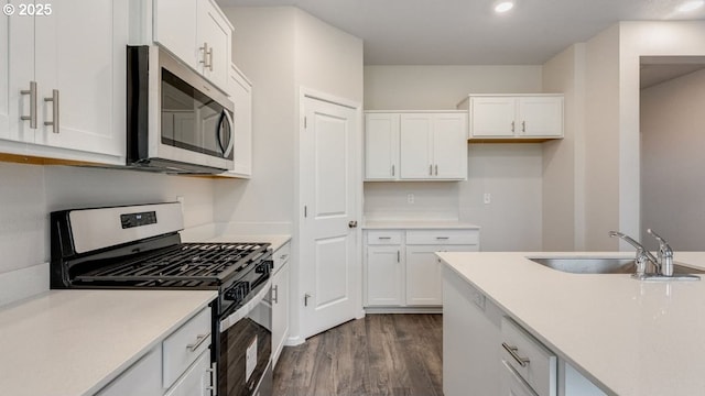 kitchen with white cabinetry, sink, dark wood-type flooring, and stainless steel appliances