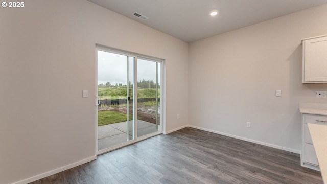 unfurnished dining area featuring dark hardwood / wood-style flooring