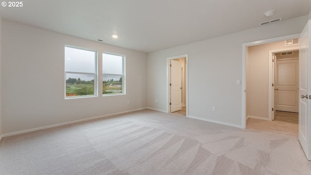 unfurnished bedroom featuring light carpet