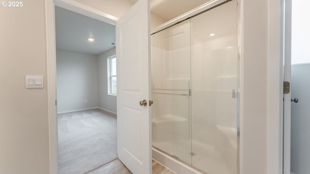 bathroom featuring a shower with shower door