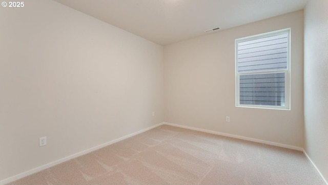 empty room featuring light colored carpet