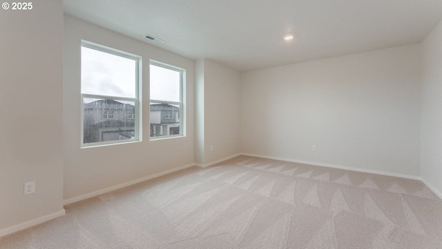 empty room with light colored carpet