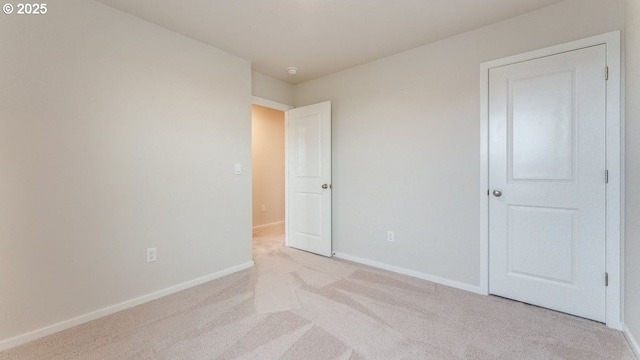 unfurnished bedroom with light colored carpet