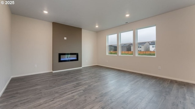 unfurnished living room with dark hardwood / wood-style flooring