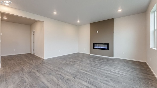 unfurnished living room with hardwood / wood-style floors