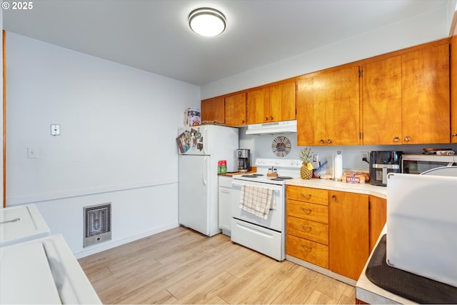 405 Redpath St, Kelso, WA 98626 - kitchen featuring white appliances, under cabinet range hood, brown cabinets, light wood finished floors, and light countertops