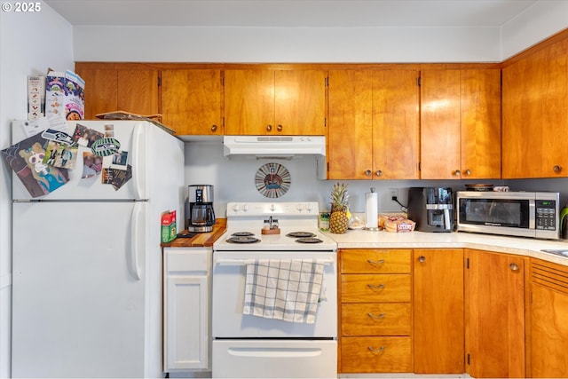 405 Redpath St, Kelso, WA 98626 - kitchen with white appliances, under cabinet range hood, brown cabinetry, and light countertops