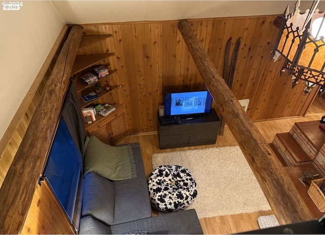 living room with hardwood / wood-style floors and wooden walls