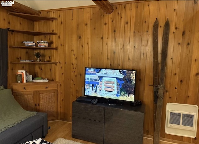 cinema room featuring heating unit, wooden walls, and light hardwood / wood-style floors