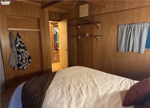 bedroom with wooden walls and a closet