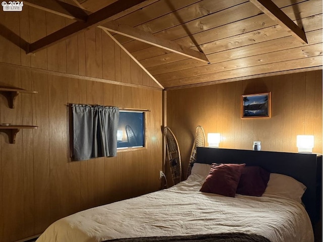 bedroom featuring vaulted ceiling, wooden walls, and wood ceiling