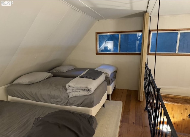 bedroom with wood-type flooring and lofted ceiling