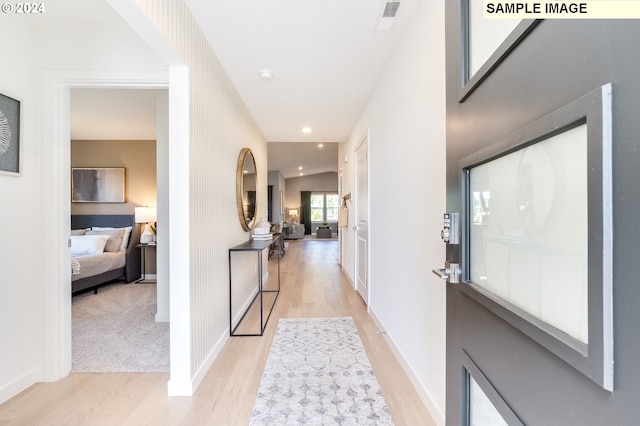 foyer entrance featuring recessed lighting, visible vents, light wood-style flooring, and baseboards