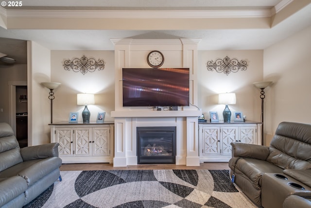 living room featuring hardwood / wood-style flooring and ornamental molding