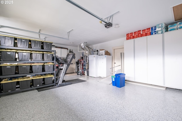 garage featuring a garage door opener and white fridge