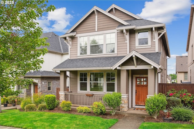 29176 SW Costa Cir E, Wilsonville, OR 97070 - craftsman-style house with covered porch, stone siding, roof with shingles, and fence
