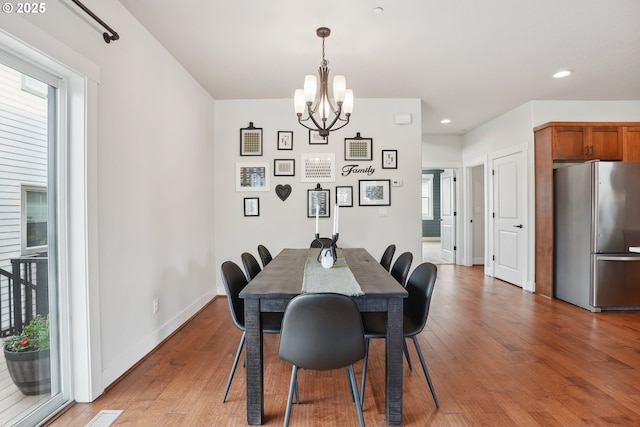 29176 SW Costa Cir E, Wilsonville, OR 97070 - dining area featuring a chandelier, light wood finished floors, recessed lighting, and baseboards