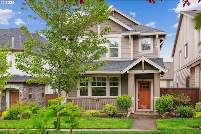 29176 SW Costa Cir E, Wilsonville, OR 97070 - craftsman inspired home with fence, a shingled roof, stone siding, and covered porch