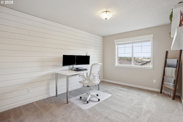 29176 SW Costa Cir E, Wilsonville, OR 97070 - carpeted home office featuring a textured ceiling, baseboards, and wooden walls
