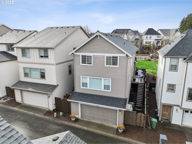 29176 SW Costa Cir E, Wilsonville, OR 97070 - view of property featuring a residential view, fence, a garage, and roof with shingles