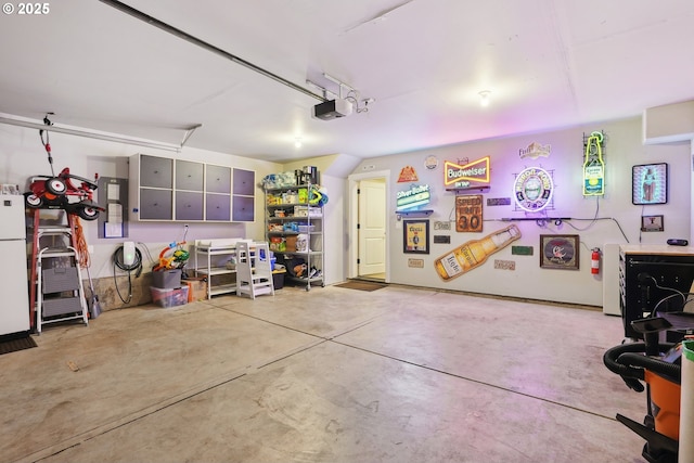 29176 SW Costa Cir E, Wilsonville, OR 97070 - garage featuring freestanding refrigerator and a garage door opener