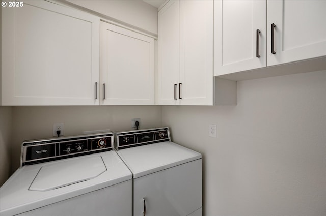 laundry area with washer and clothes dryer and cabinet space