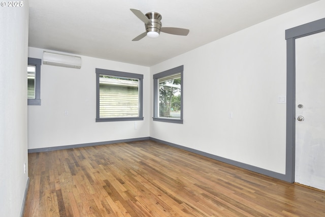 9936 SE Steele St, Portland, OR 97266 - empty room with a wall unit AC, wood finished floors, and ceiling fan