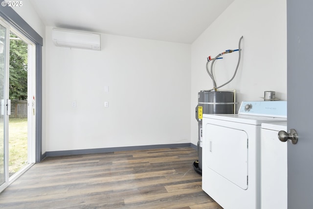 9936 SE Steele St, Portland, OR 97266 - laundry area featuring a wall mounted air conditioner, washing machine and dryer, wood finished floors, and electric water heater