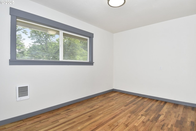9936 SE Steele St, Portland, OR 97266 - spare room with wood finished floors and heating unit