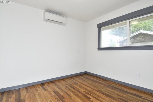 9936 SE Steele St, Portland, OR 97266 - empty room featuring a wall mounted air conditioner and dark wood-style flooring