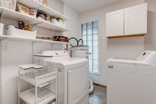 laundry area featuring cabinet space, plenty of natural light, and washer and clothes dryer