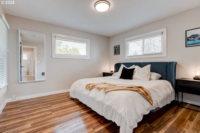 bedroom with baseboards and wood finished floors