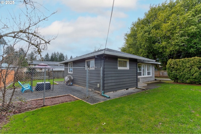 exterior space featuring a lawn and fence