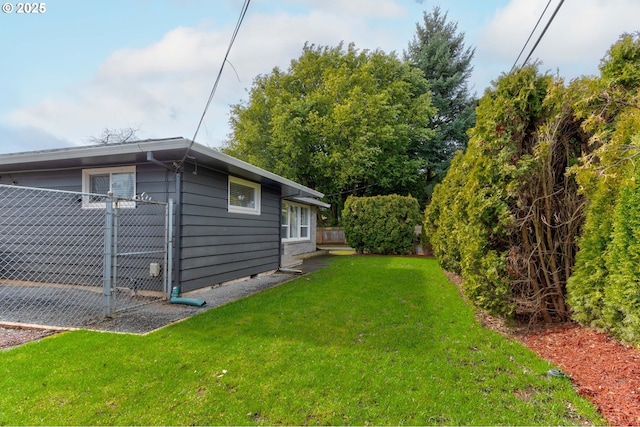 view of property exterior featuring a yard and fence