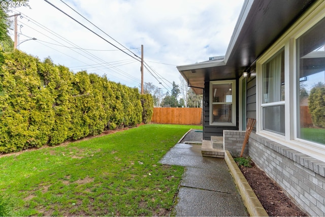 view of yard featuring a patio and fence