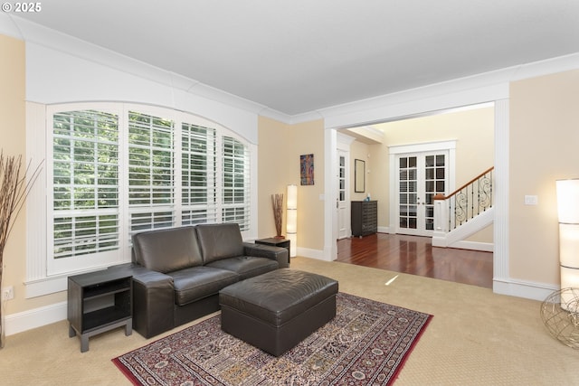 17677 Westview Dr, Lake Oswego, OR 97034 - carpeted living room featuring french doors, baseboards, stairs, and crown molding