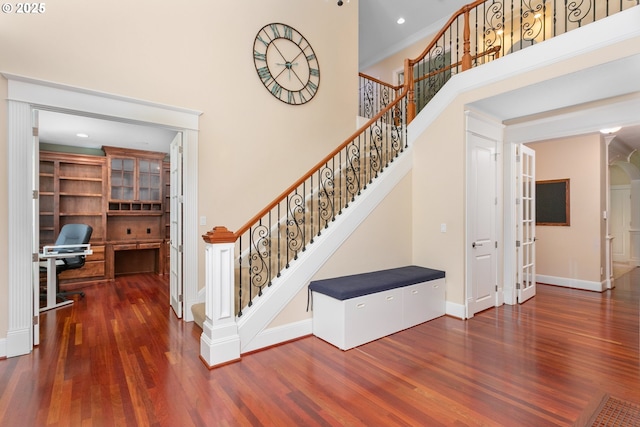 17677 Westview Dr, Lake Oswego, OR 97034 - staircase featuring wood finished floors, baseboards, french doors, a high ceiling, and recessed lighting