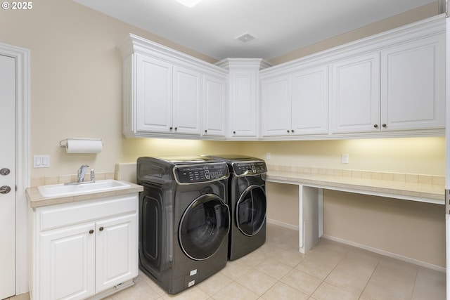 17677 Westview Dr, Lake Oswego, OR 97034 - laundry room with washing machine and dryer, cabinet space, light tile patterned flooring, and baseboards