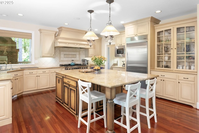 17677 Westview Dr, Lake Oswego, OR 97034 - kitchen with built in appliances, cream cabinets, custom exhaust hood, dark wood-style flooring, and recessed lighting