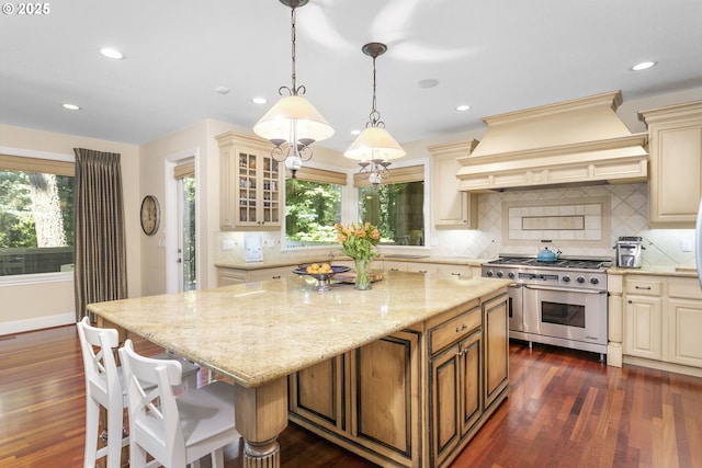17677 Westview Dr, Lake Oswego, OR 97034 - kitchen with double oven range, cream cabinetry, custom range hood, light stone countertops, and recessed lighting