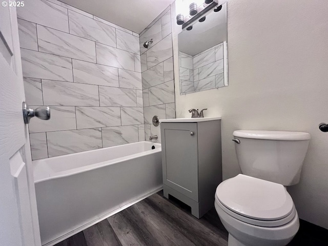 full bathroom featuring toilet, shower / washtub combination, wood finished floors, and vanity