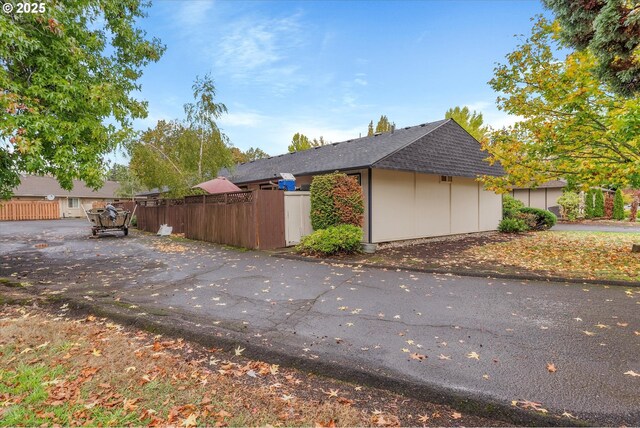 view of property exterior with a fenced front yard