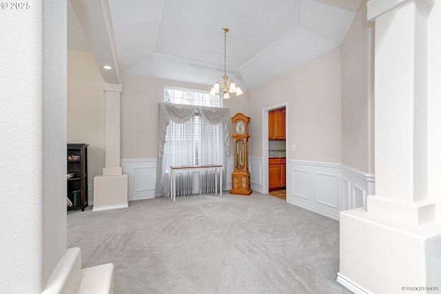 24788 E Mckenzie Valley Ct, Welches, OR 97067 - unfurnished dining area with a decorative wall, an inviting chandelier, carpet, and a wainscoted wall