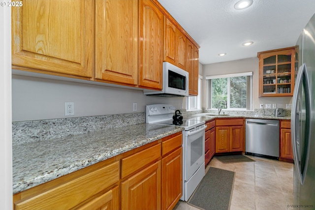 24788 E Mckenzie Valley Ct, Welches, OR 97067 - kitchen featuring a sink, recessed lighting, light stone counters, and stainless steel appliances