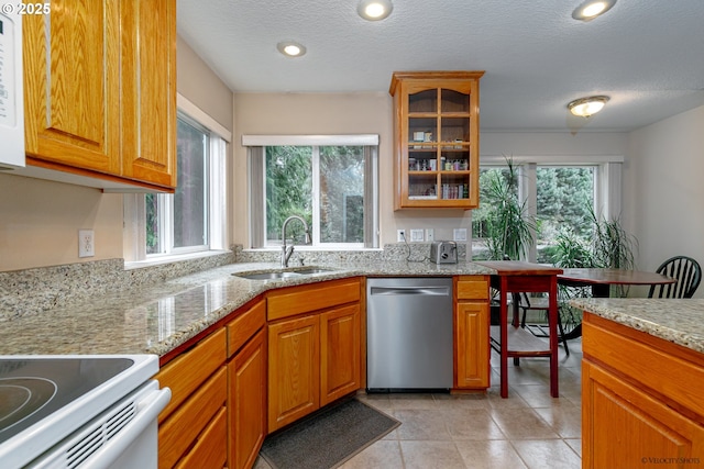 24788 E Mckenzie Valley Ct, Welches, OR 97067 - kitchen featuring light stone counters, light tile patterned floors, glass insert cabinets, dishwasher, and a sink